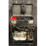 An electric Singer sewing machine, number 222K, original carry case with accessories and