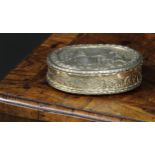 An early 20th century Dutch silver-gilt oval table snuff box, chased with topers and their wives,