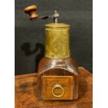 An 18th century fruitwood and brass coffee grinder or mill, articulated handle, drawer to base