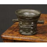 A Gothic bronze mortar, cast in relief with pilasters and fleur de lys, lug handles, 11cm high