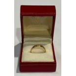 A 22ct gold wedding band, size R, marked 22ct, 3.6g, boxed