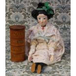 A reproduction carved and painted wooden doll, the carved and painted wooden head with black hair,