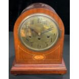 A late 19th/early 20th century mahogany dome top mantel clock, circular brass dial inscribed with