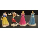 A Royal Doulton Disney Princesses figure, Cinderella, DP1, boxed; others, Snow White, DP5;