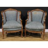A pair of Louis XV Revival beech bergère en cabriolets, stuffed-over upholstery, squab cushions,