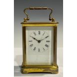 A late 19th/ early 20th century brass carriage timepiece, Roman numerals on rectangular white