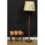 A 19th century mahogany stool, 47cm high, 56cm wide, 37cm deep; an oak standard lamp, 146cm high