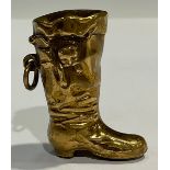 An early 20th century brass novelty vesta case, as a cat in a boot, c.1900