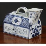 A Chinese water carrier, square spout, strap handle, painted in tones of underglaze blue with