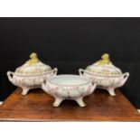 A pair of porcelain fluted oval tureens and covers decorated in polychrome with birds and flowers,