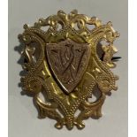 A Victorian 9ct rose and yellow gold shield shaped fob, pierced border, monogrammed, 3.5cm,