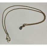 A 9ct gold necklace chain with scroll pendant, set with a diamond chip and blue stone, marked 375,