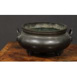 A large Chinese dark patinated bronze tripod censer, loop handles, 32cm wide