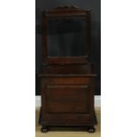 An 18th century mahogany box chair, rectangular back, hinged seat above a raised and fielded