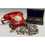 A red dial-up telephone; a set of brass engineer's/draughtsman's compasses, drawing instruments,