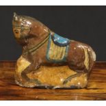 A Persian Islamic pottery model of a horse, glazed in tones of turquoise, brown and yellow, 16cm