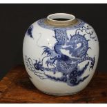A Chinese ovoid ginger jar, painted in tones of underglaze blue with a dragons chasing flaming