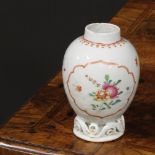 An 18th century Chinese ovoid tea caddy, painted in the famille rose palette with flowers and