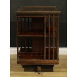 An early 20th century revolving bookcase, 87cm high, 60cm square