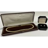 A single strand of uniform cultured pearls, 9ct gold clasp, boxed; a pair of 9ct gold cultured pearl