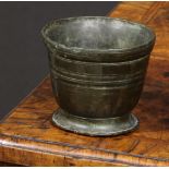 A 17th/18th century bronze mortar, of small proportions, reeded bands, 7cm high