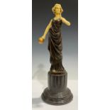 A large bronzed figure, as an Art Deco lady with sphere, composite marble base, 43cm high