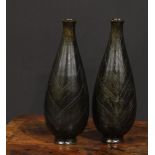 A pair of Japanese dark patinated bronze slender ovoid vases, cast in shallow relief with lotus