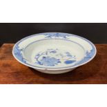 An 18th century Chinese circular basin, painted in tones of underglaze blue with flowers and