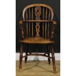A 19th century East Midlands ash and elm Windsor elbow chair, low hoop back, shaped and pierced