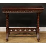 A Victorian Neo-Gothic oak card table, hinged top enclosing a baize lined playing surface above a