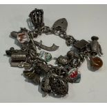 A silver charm bracelet with padlock and 20 charms