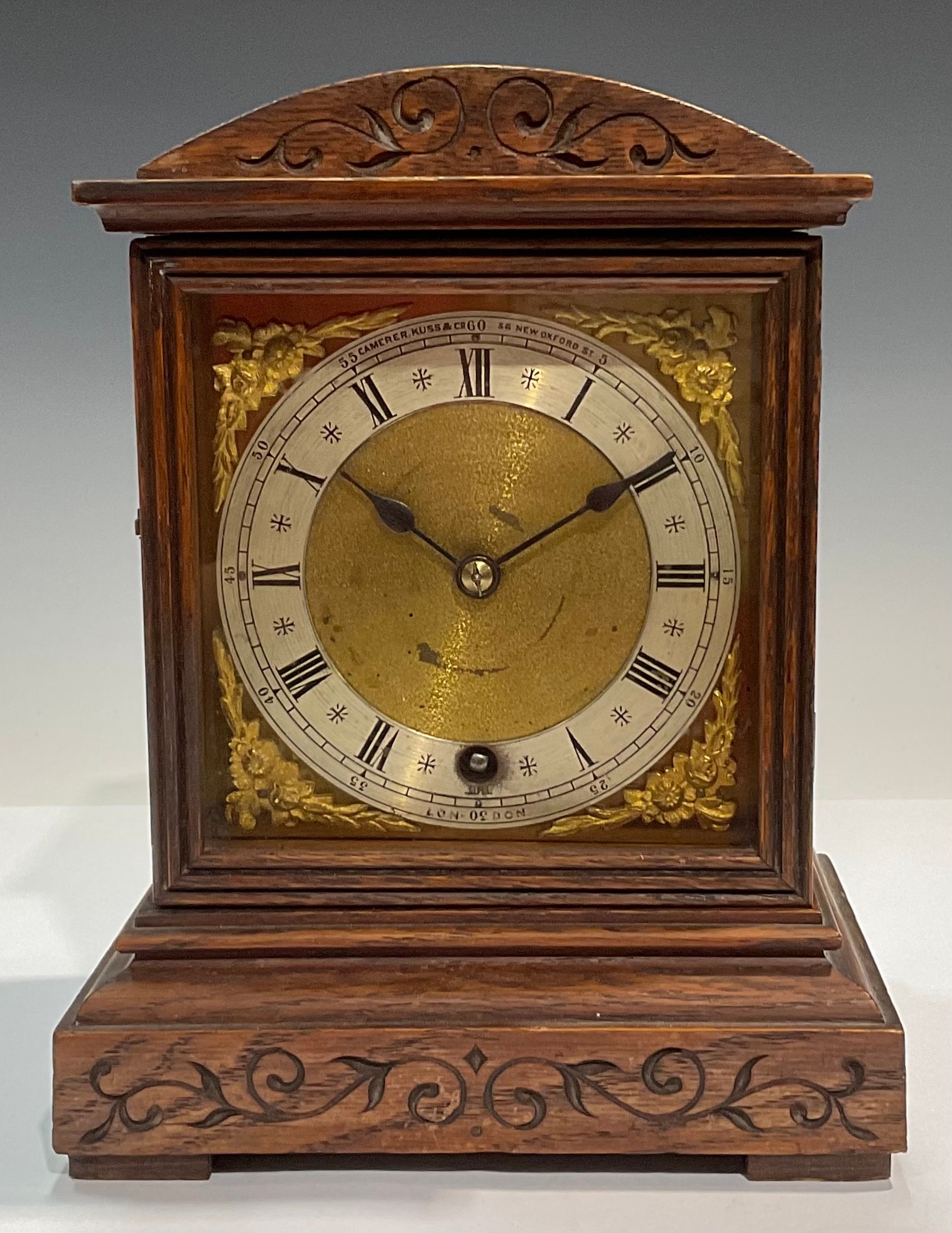 An oak cased mantel clock, Camerer Cuss and Co, London, Roman numerals on silvered chapter ring,
