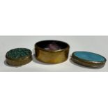 An oval guilloche enamel pill box; another similar; a turquoise inlaid pill box (3)