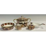 A Royal Crown Derby Imari 1128 pattern tea strainer on stand, first quality; an 1128 pattern