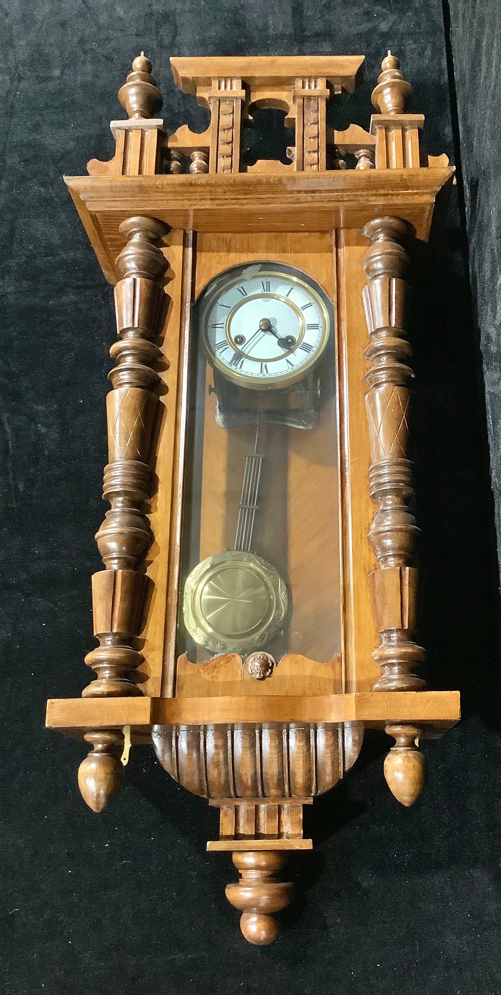 A Vienna wall clock, white enamel dial, Roman numerals, twin winding holes, pendulum, 96cm