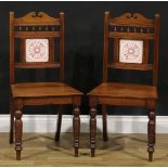 A pair of Aesthetic Movement walnut hall chairs, 85.5cm high, 42.5cm wide, the seat 33cm deep (2)