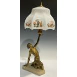 An Art Deco table lamp, modelled as a scantily clad female raising the shade aloft, 46cm high