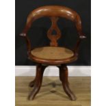 A late Victorian/Edwardian swivel desk chair, 85cm high, 63cm wide, the seat 43cm wide and 42cm deep