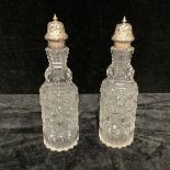 A pair of Victorian silver mounted cut glass sugar casters, Birmingham 1879