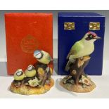 A Royal Crown Derby model, of a Blue Tit and Chicks, cased; another, Green Woodpecker, cased (2)