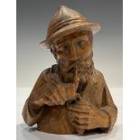 A Black Forest novelty wood carving, The Pipe Smoker, 12cm