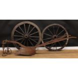 A Ransomes RHR plough, 273cm long; a cart wheel or wagon wheel, 128cm diameter; another, 115.5cm