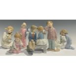 A Nao Lladro figural group of a young girl and boy on a bench, 16cm high; a Nao Llado figure of a