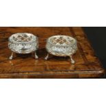 A pair of large early George III silver salts, gadrooned and pierced borders, ball and claw feet,