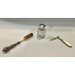 A silver top scent bottle; a hallmarked silver and mother of pearl penknife; a silver and bone brush