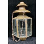 A brass octagonal mosque lantern, each of the eight panels with bevelled glass, 40cm, with three