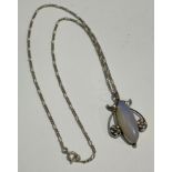 An Art Nouveau moonstone and silver pendant on chain