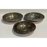 A silver dish, inverted rim, 12cm diameter, London 1992; another, 1976; a smaller silver dish,