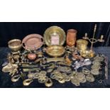 A collection of horse brasses, a fire iron stand, a brass candelabra, assorted brass miniatures,