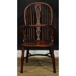 A 19th century yew and beech Windsor elbow chair, hoop back, shaped and pierced splat, one-piece